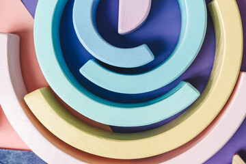 background with circles. Wooden kids toys on colourful paper. Educational toys blocks. Toys for...