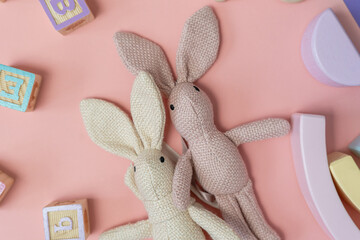 Bunny close up with toys, blocks on the pink background. activities for kids. preschool,...