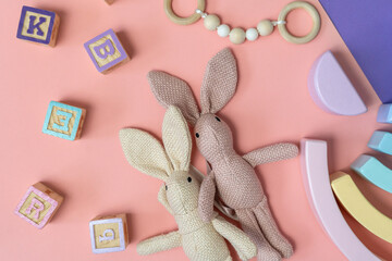 Bunny close up with toys, blocks on the pink background. activities for kids. preschool,...