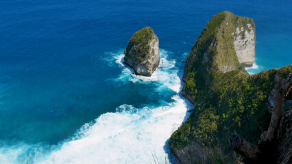 Turquoise ocean sea water white wave splashing deep blue sea. Bird eye view monster wave splash on rock. Tropical sea beach in summer seaside outdoor. Ocean island beautiful dramatic landscape.