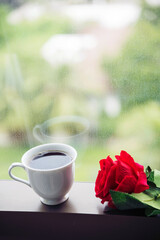 Tabletop black coffee cup red rose on wood table background with empty copy space. Espresso shot caffeine hot coffee cup in cafe. Top view Black caffeine dark beverage in cafeteria with copy space
