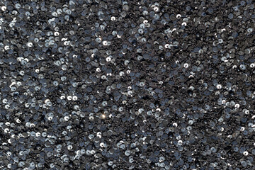 Black fabric strewn with sequins and small beads