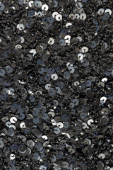 Black fabric strewn with sequins and small beads