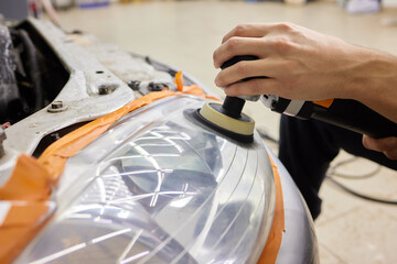 Big headlight cleaning on the car with power buffer machine at service station ,Before and after...