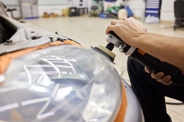 Big headlight cleaning on the car with power buffer machine at service station ,Before and after...
