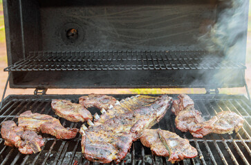 BBQ grill is used to hot smoke variety of juicy pork meats
