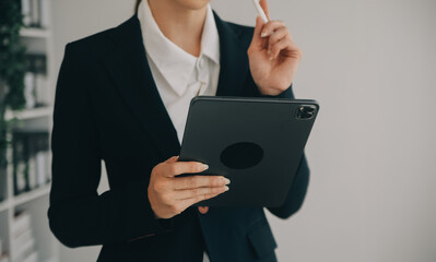 Beautiful female call center operator working on computer in office