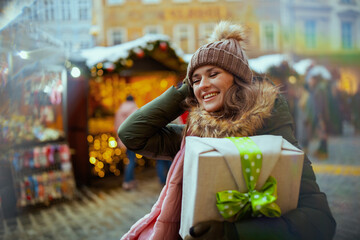 happy young woman at christmas fair in city