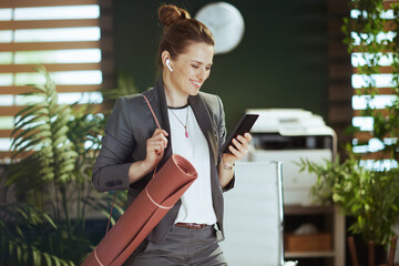 smiling business woman at work using smartphone applications