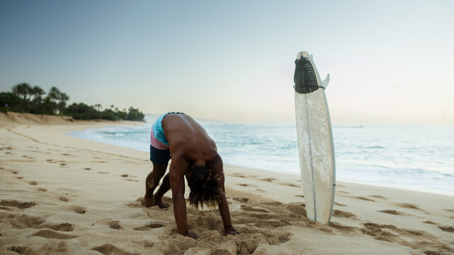 Man surfer stretch before surfing - Powered by Adobe