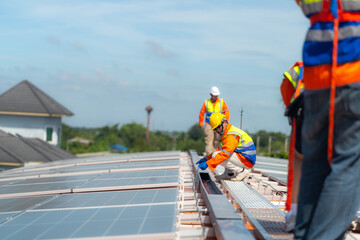 Worker Technicians are working to construct solar panels system on roof. Installing solar photovoltaic panel system. Alternative energy ecological concept. Renewable clean energy technology concept.