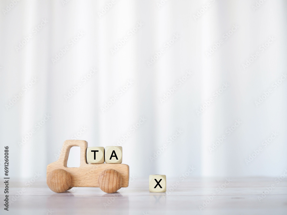 Poster Wooden toy car and Wooden blocks with the word TAX . The concept for paying TAX for car in future