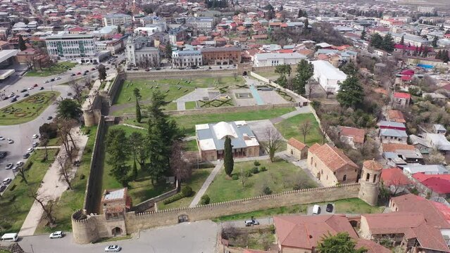 Panoramic aerial view of Telavi cityscape with residential districts and architectural complex of Batonis Tsikhe Castle in spring, Georgia