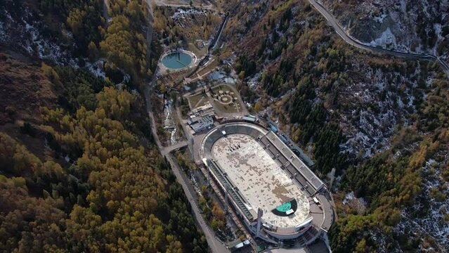 Aerial view tilting over the Medeu stadium, sunny, autumn day in Kazakhstan