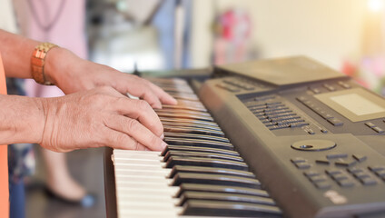 Close-up of Hands middle age man playing grand piano.
