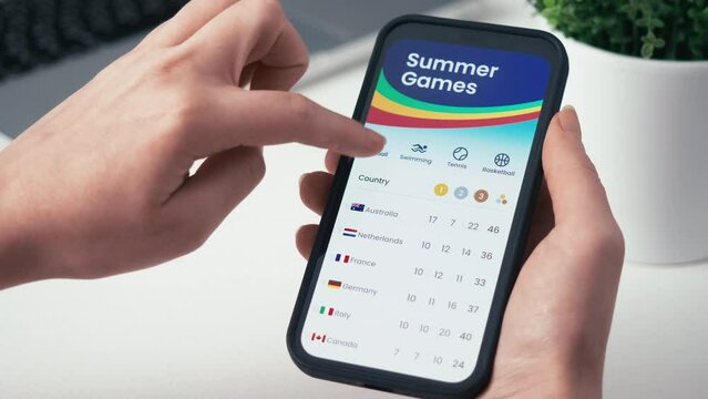 Checking summer sports medal tally. Scrolling through the summer athletic competition results table online. Fictional interface.