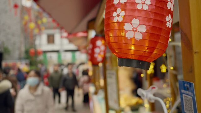 People shopping during Chinese New Year, New Year shopping atmosphere, red spring couplets, New Year paintings, Chinese festival decorations