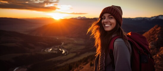 Young woman smiling at sunset over Aspen, Colorado mountains. - obrazy, fototapety, plakaty