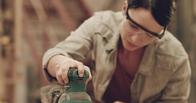 Carpenter woman, sanding tools and workshop for wood with creativity, thinking and glasses for safety. Woodwork expert, manufacturing and furniture production with industrial machine on factory table