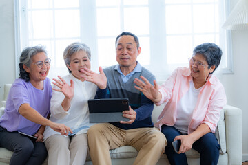 Happiness of the group females and male elderly talking with Video Call from smart tablet. Senior...