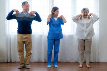 Portrait of elderly smiling Asian woman and people aerobics in nursery house. Seniors are moving...
