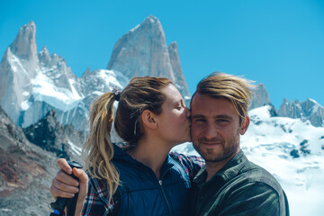 young couple take photo of them self with the FitzRoy chalten mountain at the back