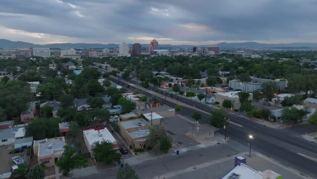 Albuquerque neighborhood at sunrise with a view of the city skyline in New Mexico. Aerial.