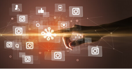 Hand pressing social media multimedia application screen with media icons on futuristic concept