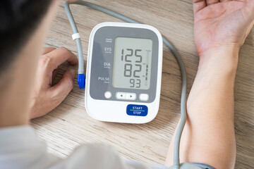 man check blood pressure monitor and heart rate monitor with digital pressure gauge. Health care...