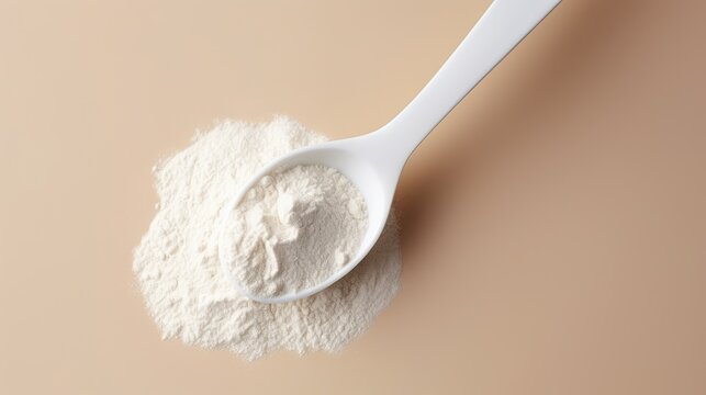Spoon with collagen or protein powder on pastel background. Natural supplement for beauty and health of skin, bones, joints and intestines. Plant or fish based. Flatley, top view.