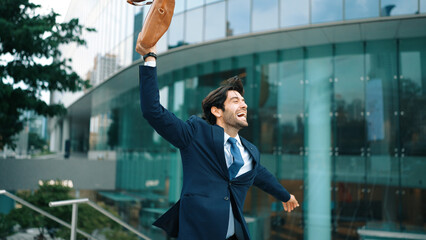 Successful business man celebrate for getting promotion while walking to office. Caucasian receive good news about sales increase or successful project. Manager feel overjoy and happy. Exultant.