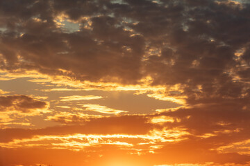 Golden sunset on the sky with clouds