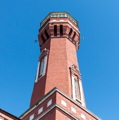 Fototapeta na wymiar Red brick tower against a blue sky
