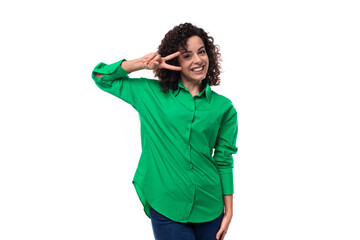 smiling office brunette woman with curly hair dressed in a green shirt on a white background