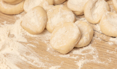 Dough for dumplings on a wooden table