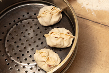 Raw manti in a pressure cooker