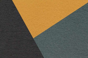 Texture of craft black, orange and green shade color paper background, macro. Vintage abstract...