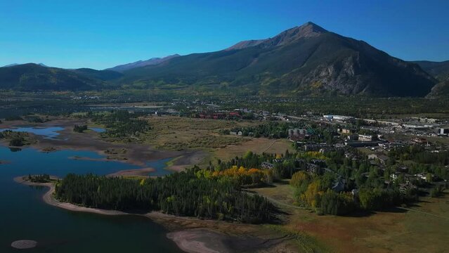 Early fall colors Aspen trees downtown Frisco Main Street  Lake Dillon islands Colorado aerial cinematic drone morning view Frisco Breckenridge Silverthorne Ten Mile Range pan up reveal forward motion