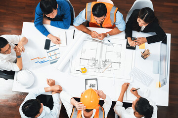 Top view banner of diverse group of civil engineer and client working together on architectural project, reviewing construction plan and building blueprint at meeting table. Prudent - obrazy, fototapety, plakaty