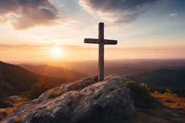 Christian cross on the mountain at sunset. A symbol of the resurrection of Jesus Christ.