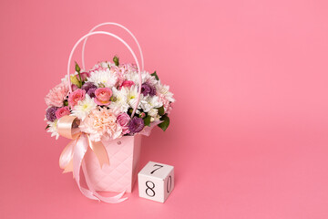 Number 8 with fresh spring flowers on bright pink background. Minimal Women's day, March 8th or birthday concept