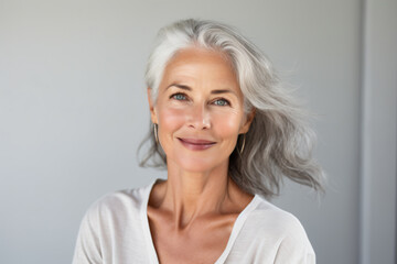 Fototapeta premium a woman with grey hair and a white shirt