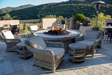 Chairs and side tables around fire pit for gathering.