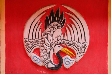 The pattern of a crane colour hand painting symbolize longevity in an ancient traditional Malaysian Chinese heritage temple which is located in the town centre of Melaka, Malaysia.