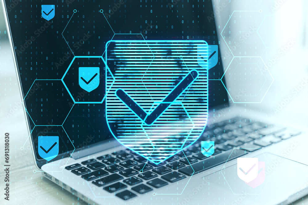 Poster Close up of laptop at desk with glowing hexagonal shield hologram and binary coding on blurry background. Safety and internet concept. Double exposure.