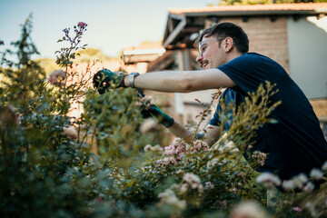 A man enjoying his gardening hobby, cultivating a beautiful outdoor space right at his doorstep