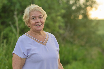 Senior woman smiles in a natural setting, radiating joy. Perfect for content on aging positively...
