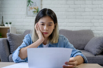 Financial household debt concept. Stressed young asian woman trying to find money to pay credit...