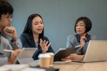 Group of diverse Asian businesspeople are in the meeting, planning their project strategies together