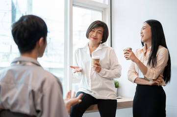 Group of happy diverse Asian businesspeople colleagues are enjoying talking during a coffee break.